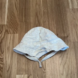 Vit hatt från Zara - Söt vit hatt från Zara med broderade blommor och knytband. Perfekt för soliga dagar.