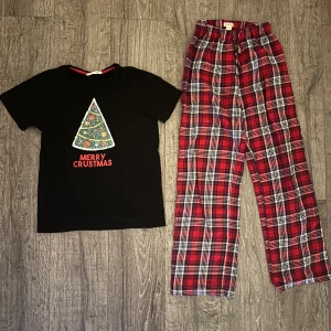 Svart jultröja & pyjamasbyxor - Så fint julsett 😍 Strl 146/152. T-shirten har vändbara paljetter. På ett sätt är det en julgran och vänder man på dom är det en pizzaslice 🤗 T-shirten är från Kappahl och pyjamasbyxorma är från Gina Trico. Knappt använt, jättefint skick. Passar både tjej och kille. 