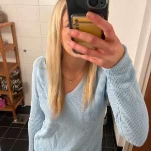 Ljusblå ribbad tröja - Säljer en ljusblå ribbad tröja med v-ringning och långa ärmar. Fin blå färg, från Vero Moda