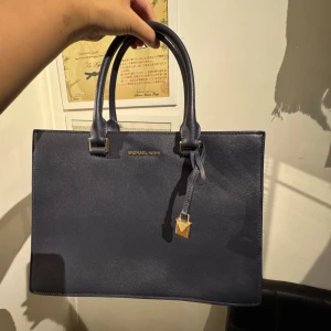 michael kors medium handväska - säljer denna fina mörkblåa michael kors väskan & har aldrig använts💙 perfekt som jobb väska eller att ha med sig till skolan! kan mötas upp annars står köparen för frakt💙😇