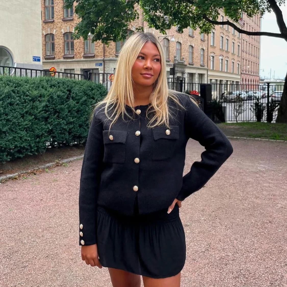 Svart kofta med guldknappar