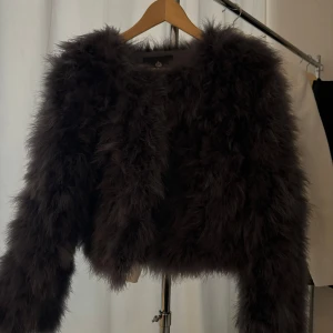 Brun pälsjacka från Chelsea - Säljer en supercool brun pälsjacka från Chelsea i storlek S. Den är perfekt för att ge din outfit en lyxig touch. Jackan har långa ärmar och är riktigt fluffig och mysig. Perfekt för höst och vinter när du vill hålla dig varm och stilren. 🐻✨