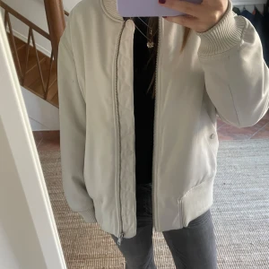Beige bomberjacka - Jättesnygg bomberjacka! Liten fläck på ena ärmen, se sista bilden.