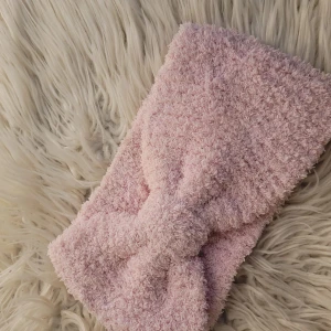 Rosa fluffigt diadem - Supergulligt rosa diadem i fluffigt material som är perfekt för att hålla håret borta från ansiktet. Det har en söt rosett framtill som ger en extra touch av stil. Perfekt för mysiga hemmakvällar eller som en söt accessoar till din outfit.