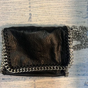 Tiamo väska  - Säljer en svart väska med silver kedja från märket tiamo. Super fint skick då den knappt är använd. 💕