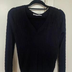 Marinblå Ralph lauren liknande tröja - Snygg marinblå ribbad tröja från Zara med v-ringning. Perfekt för en stilren look. Säljer för den kommer inte till användning. Använd typ 2 gånger.💙