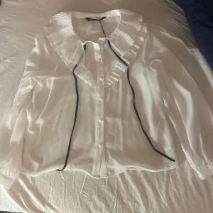 Vit festtopp zara  - Snygg topp med knytning vid halsen från zara, säljer på grund av att den aldrig kom till användning, bara provad med lappen kvar. 