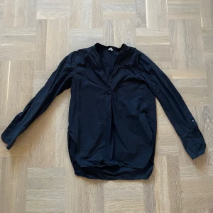 Svart långärmad henley - Säljer en stilren svart henley med långa ärmar. Skjortan har en enkel design med en knappdetalj framtill och är perfekt för både vardag och fest. Storlek 36 🖤