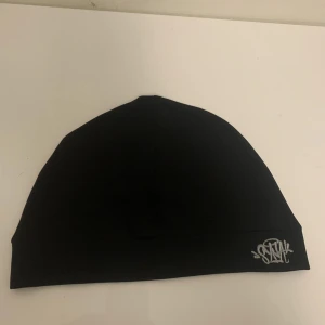 Syna world mössa - Ny endast testad