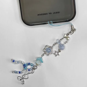 Jellyfish 🪼 Blå mobil- och väskdekoration med pärlor och stjärnor - Charmig dekoration i blått och silver med pärlor, stjärnor och blommor. Perfekt för att ge din mobil eller väska en personlig touch. Den har en mix av olika blå nyanser och silverdetaljer som ger en lekfull och stilren look. Längd: 19 cm. 🪼🪼🪼