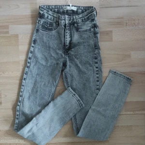 Grå jeans från Perfect Jeans - Jeans från Gina Tricot i modellen Molly. De är i storlek XS och har en klassisk femficksdesign med knapp och dragkedja framtill. Knappt använda.