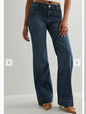 Mörkblå bootcut jeans med hög midja - Snygga mörkblå jeans med bootcut passform och hög midja. Säljer då dom inte passar mig använt en gång!