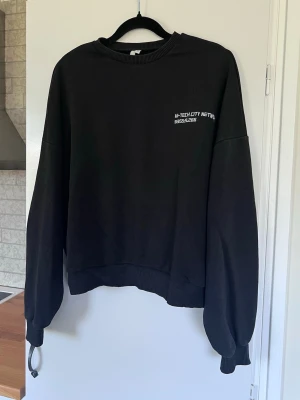 Svart oversized sweatshirt - En svart oversized sweatshirt med vit text. Stor i storleken så passar även S/M. Granska bilderna noga!