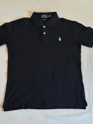 Polo Ralph Lauren Black Polo Shirt White Pony Logo Classic - Size: S Condition: New | Color: Black | Material: 100% Cotton | Dimensions: Armpit Width ≈ 50cm & Length ≈ 68cm ||| Ships within 24 hours ||| Any questions? Feel free to ask!
