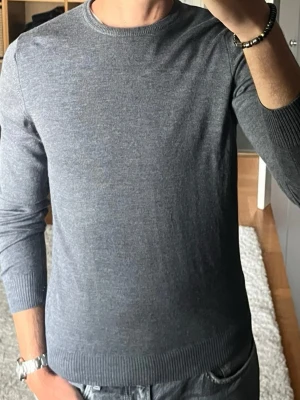 Stenströms merinotröja i mörkgrå - stl M - Stenströms merinotröja i mörkgrå, storlek M. 100% merinoull från Zegna Baruffa, tunn och mjuk utan att sticka. Personen på bilden är 189cm, väger 78kg.  Använd med ett litet hål som lagats nere till höger på tröjan, se bild 5. Annars hel och fin, inga fläckar.  Rök- och djurfritt hem. Skriv gärna om du vill ha fler bilder eller undrar något!