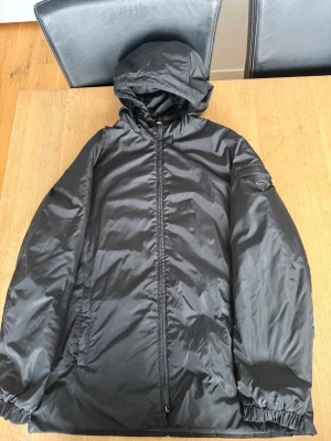 Svart Prada jacka  - Svarta Prada jacka i storlek S, stilren och snygg perfekt för hösten! Väldigt bra skick inga skador, hål eller fläckar utan endast enklare tecken på användning! 