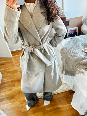  kappa Vero Moda - Ljusgrå kappa från veromoda. Sitter supersnyggt. Använd två gånger alltså i nytt skick. Egna bilder. Hör av dig vid intresse och lägg gärna prisförslag. Strl S