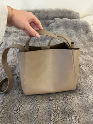 Beige axelremsväska ginatricot  - Stilren beige handväska från ginatricot, inga defekter! 