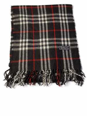 Rutig halsduk från Burberry i lam ull - Klassisk halsduk från Burberry i 100% lammull. Svart bas med vitt och rött rutmönster samt fransar i ändarna. Märkt 'Made in England'. Perfekt accessoar för att lyfta din outfit med en tidlös burberry stil