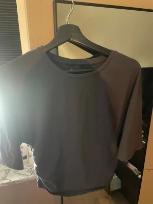Svart t-shirt från Gina Tricot - En basic svart t-shirt från Gina Tricot i storlek L. T-shirten har rund halsringning och korta ärmar. Tillverkad i mjuk bomull som känns skön mot huden. Perfekt att matcha med jeans eller kjol för en enkel och clean look.