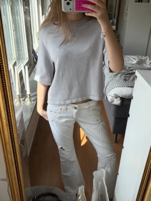 Ljus grå topp med halvlånga ärmar !! - En ljusgrå topp med croppad passform och halvlånga ärmar. Enkel och stilren design utan mönster, perfekt för dig som gillar en clean look och passar till allt💕