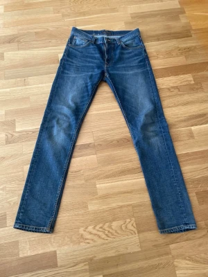 Nudie Solid Ollie - Säljer ett par feta nudie jeans i modellen solid ollie, vilket är en mer straight modell! Midja: 42 cm, Ytterben: 110 cm, Benöppning: 17,5 cm. Hör gärna av er vid frågor!
