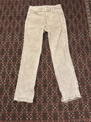 Ljusgrå raka jeans - Säljer ett par ljusgrå jeans med rak passform och klassisk femficksdesign. Jeansen har bälteshällor och knappgylf. Perfekta för dig som gillar en stilren och enkel look. OBS Gjorda flared hemma alltså inte omsydda utan klippta trådar och klippt på sidan jag antar att dem passar W 34