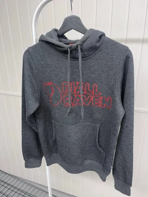 Grå hoodie från Fjällräven XS - Mörkgrå hoodie från Fjällräven med röd broderad logga på bröstet. 