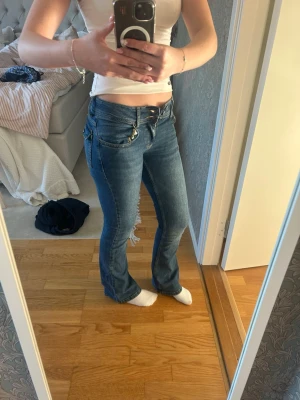 Mörkblå lowwaist jeans - Säljer ett par skit snygga mörkblåa low waist jeans ifrån RYVLS (kids brandstore) pga för små! Är i storlek 170 men är som XS, jag är även 164cm lång men de är för små i midjan och inte i längden💕skriv för mått vid midjan eller annat! (jag har 27cm i midje längd)