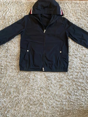 Moncler windbreaker  - Säljer denna moncler windbreaker i färgen svart jackan har en brännskada under moncler märket på vänster arm annars är den i fint skick. Storlek S Kan gå ner i pris