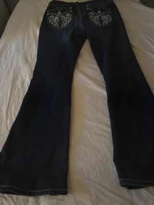 Mörkblå bootcut jeans med brodyr - Snygga mörkblå bootcut jeans från Gina tricot med dekorerade fickor ibak💕