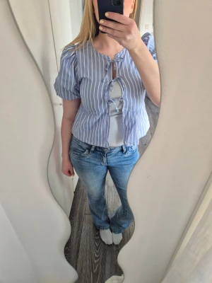 Blue striped tie-front blouse 💙 - Cute blue and white striped blouse with tie-front details. Light and comfortable to wear, perfect for spring and summer outfits. Looks great with jeans, skirts or shorts.Only worn a few times. Selling to clear out my wardrobe❣️Trendy tie-front design❣️Lightweight and easy to style❣️Perfect for everyday wear or summer outfits
