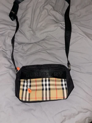 Burberry väska 1:1kopia - Hej de dags att sälja min burberry väska då jag inget använder den. Det är 1:1kopia och har två fickor, riktigt fin väska.        