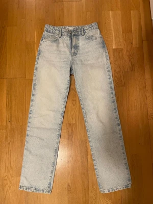 Ljusblå raka jeans från Zara - Säljer ett par ljusblå raka jeans från Zara i storlek 34. Jeansen har klassisk femficksdesign, hög midja och är tillverkade i ett slitstarkt denimtyg. Perfekta för en avslappnad och trendig look.