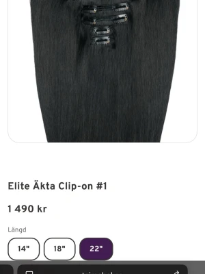 Elite Äkta Clip-on hårförlängning - Säljer en svart äkta hårförlängning från Elite med clip-on fästen. Längden är 22 tum och håret är rakt och naturligt. Perfekt för dig som vill ha längre och fylligare hår på ett enkelt sätt.