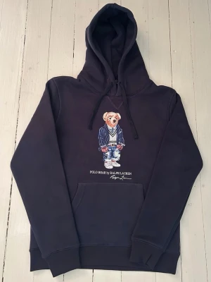 Ralph Lauren polo bear hoodie herr storlek S  - Hej! Säljer denna riktigt schyssta polo bear hoodie från Ralph Lauren. Den är i storlek M men sitter en storlek litet och passar därför som en S. Den är endast använd någon enstaka gång och är därmed i ett nyskick (om den ser fläckig/solblekt ut är det endast pga dåligt fotoljus). Original lappar och påse finns kvar och medföljer naturligtvis vid köp. Jag fraktar alltid snabbt! Mvh