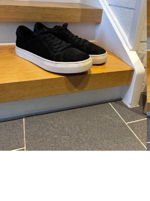 Svarta sneakers från Vagabond - Stilrena svarta sneakers från Vagabond med ovandel i mocka och klassisk vit sula. Lågt skaft och snörning framtill. Perfekta för en clean och avslappnad look. Jag fick dom under jul så dom är nya och använda 2-3 gånger bara