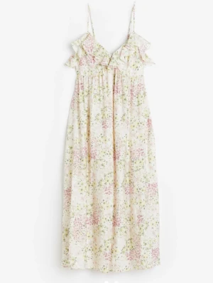 Blommig sommarklänning med volang - Söt sommarklänning med smala axelband och volangdetaljer vid bysten. Klänningen är vit med blommigt mönster i pastelliga toner av rosa, gult och grönt. Lätt och luftig modell i mjukt tyg, perfekt för varma dagar.