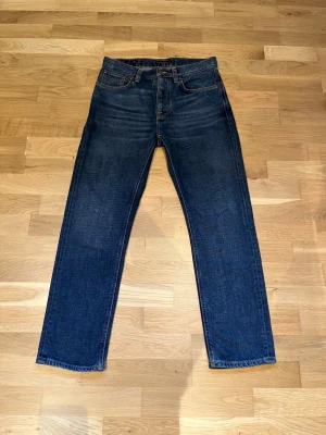 Nudie jeans W30 L30 - Nudie jeans storlek 30,30. Osäker på modell då de inte används och etiketten har tvättats bort. Trodde det var "grim tim", men inte säker.   Utgå ifrån måtten: Midja: 42 cm Stussvidd: 51,5 cm Innerbenslängd: 73 cm