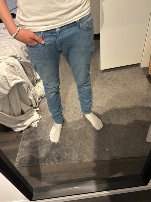  Replay Ljusblå slim fit jeans - Snygga ljusblå slim fit jeans med klassisk femficksdesign och normal midja. Jeansen har en modern, smal passform och är tillverkade i ett mjukt denimtyg som ger en bekväm känsla hela dagen. L32