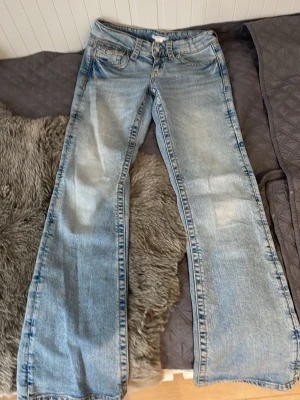 Ljusblå flared jeans  - Ljusblåa Lågmidjade flared jeans från Gina Tricot med storlek 158. Är varsamt andvända och ser helt nya ut.