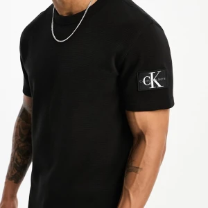 Svart t-shirt från Calvin Klein - Svart t-shirt från Calvin Klein Jeans i strukturerat tyg. Nypris: 549kr.