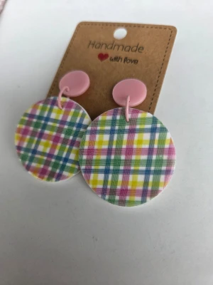 Runda handgjorda örhängen med rutigt mönster - Unika handgjorda örhängen med stora runda plattor i färgglatt rutigt mönster i rosa, gult, grönt och blått. Örhängena har rosa detaljer och är gjorda för hand av mig i polymerlera.