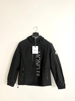 Moncler windbreaker i svart  M - Moncler Windbreaker i svart . Helt ny med tagg kvar. Riktigt clean färg och perfekt nu till våren/sommaren. Storlek M.