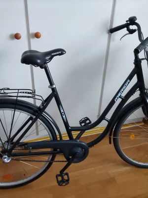 Svart nyrenoverad Merida damcykel tre växlad  - Säljer en svart damcykel från Merida med 3 växlar och ny växel förare och vajer nya däck och innerslangar. Nya trampor. Så den är nyrenoverad... klassisk ram, pakethållare och kedjeskydd. Perfekt för dig som vill ha en smidig cykel till vardagen.