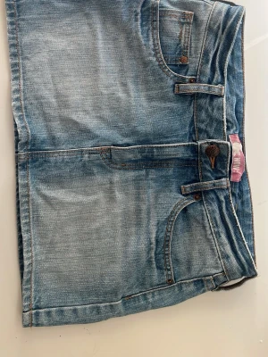 Blå jeanskjol  - Säljer denna snygga blå jeanskjolen med fickor. Till salu  då den blivit för liten för mig. Passande nu till sommaren. Kontakta mig gärna vid intresse!