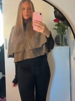 Stickad poncho - Fin stickad poncho med knappar, den har tjockt & skönt material 💕ursäktar de dåliga bilderna har screenat från min tiktok men kan skicka bättre om det önskas!