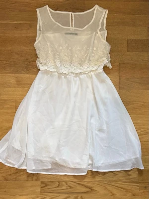 Vit klänning  - Vit klänning med spets volang 