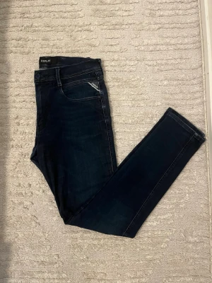 Mörkblå jeans från Replay - Snygga mörkblå jeans you'd vilja ha i garderoben! Klassisk femficksmodell med Replay-logga på fickan, smal passform stats och stretchigt denimtyg för extra komfort. Perfekta till en avslappnad look och funkar året runt.