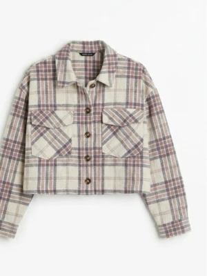 Rutig cropped overshirt i beige och lila - Trendig overshirt med rutigt mönster i beige, lila och grå toner. Croppad modell med stora bröstfickor och knappar framtill. Klassisk krage och långa ärmar. Perfekt för lager på lager och en avslappnad streetstyle-look.